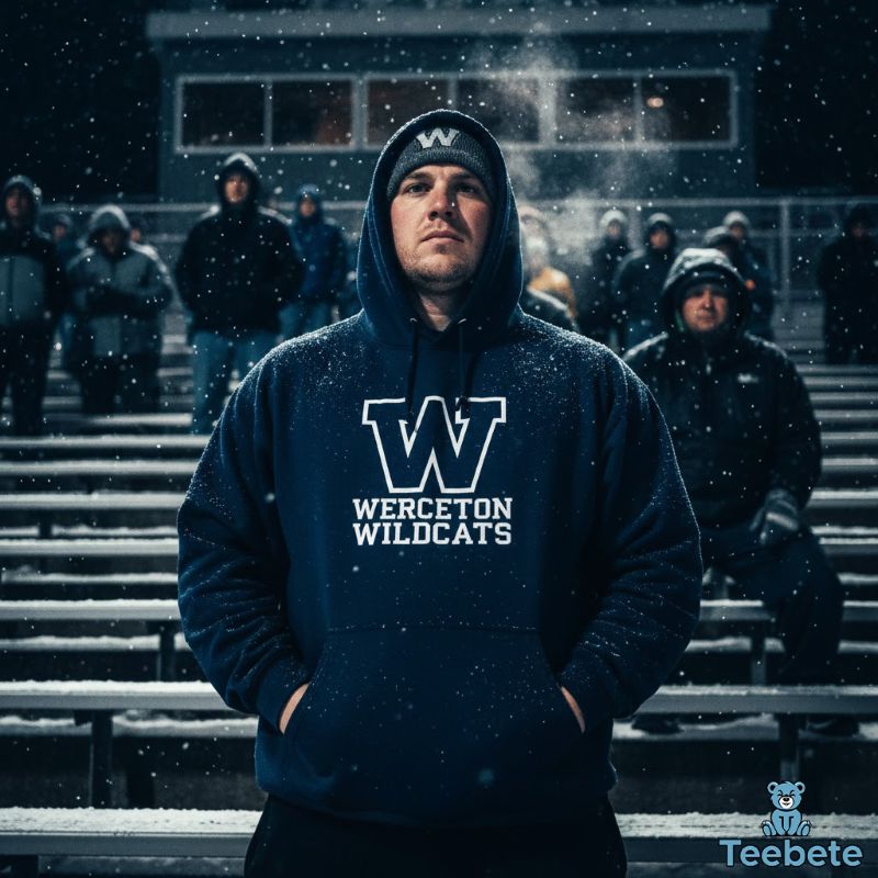 Fan in football hoodie at snowy outdoor stadium showing cold-weather game dedication