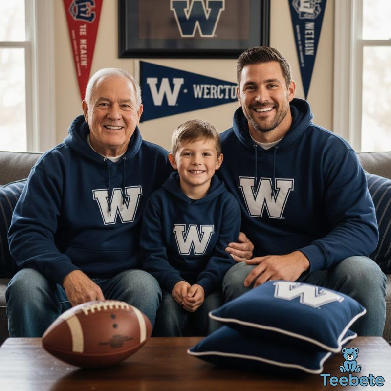Grandfather, father, and son wearing matching football team hoodies watching game together
